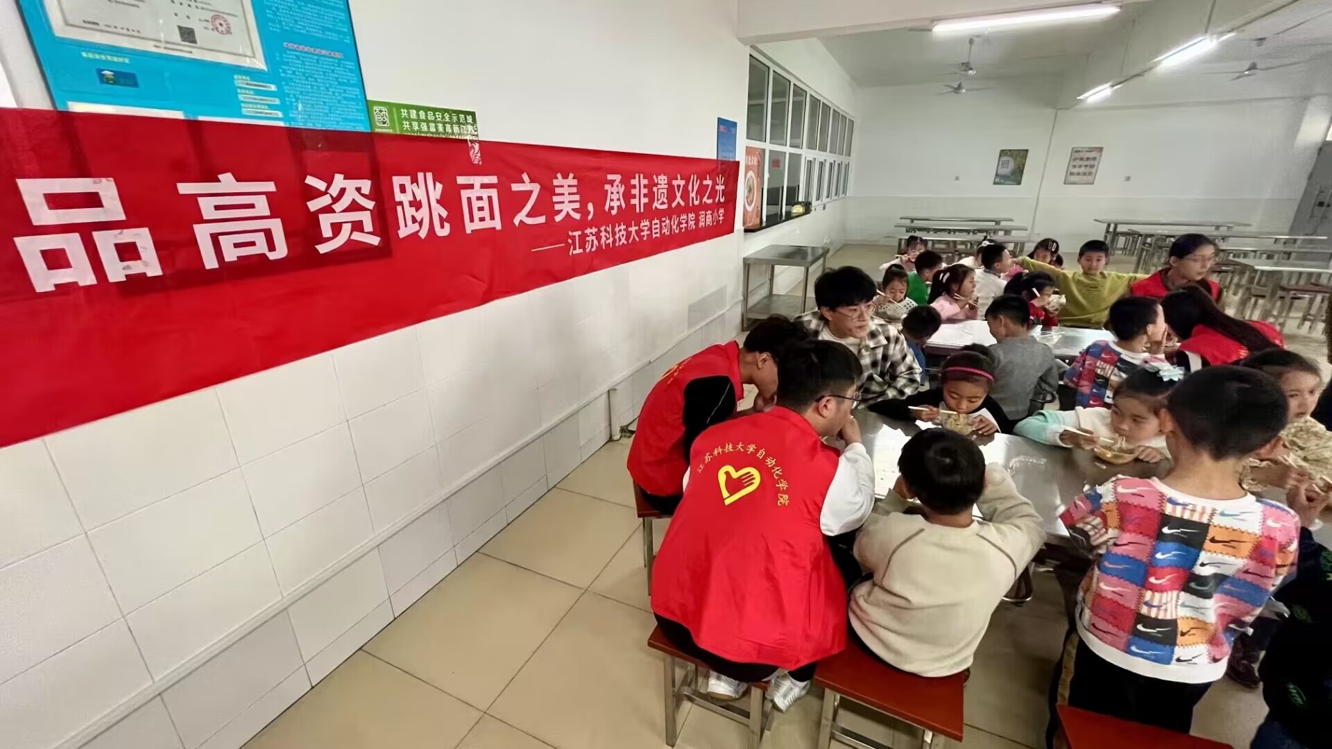 1682688148841646.jpg 图为镇江市润商小学一年级一班同学与必赢bwin官网登录入口自动化学院志愿者一同品尝高资跳面.jpg